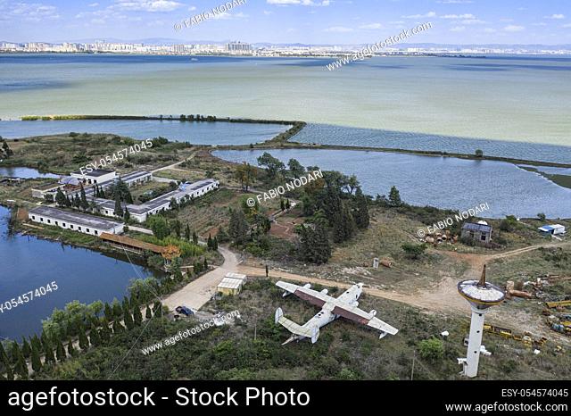 Aerial view of Dianchi lake and Kunming with abandoned airplane on foreground