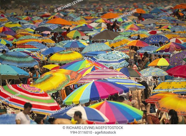 Thousands of beachgoers try to beat the oppressive heat and escape to Coney Island in Brooklyn in New York and literally pack the beach on Sunday, July 1, 2018