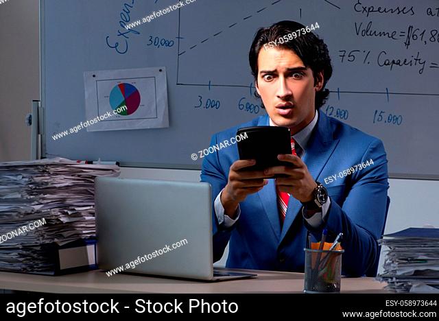 Young elegant financial specialist working in the office night time