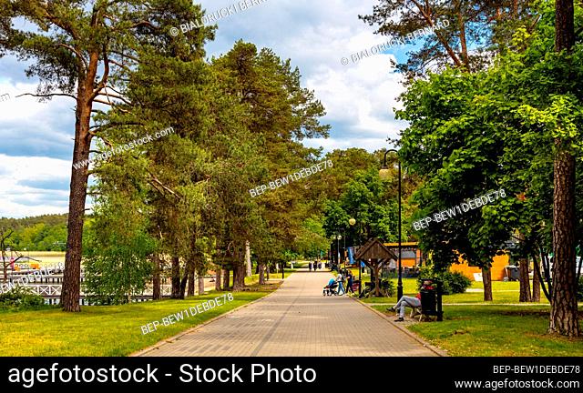 Augustow, Poland - June 1, 2021: Touristic boulevard and public beach at Necko lake shore in Masuria lake district resort town of Augustow in Podlaskie...