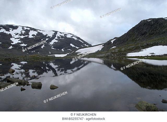 cloud-covered mountains at a mountain lake, Norway, Jotunheimen National Park