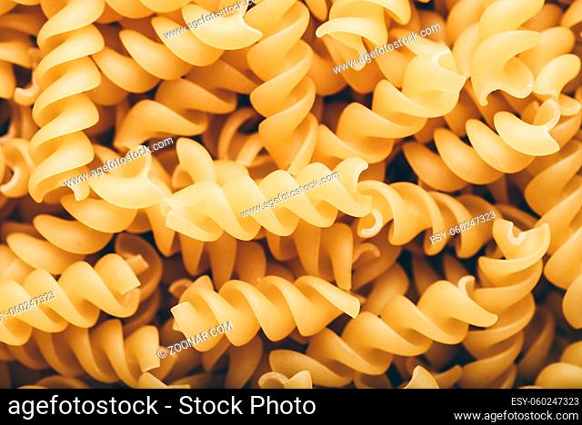 Background of Italian whole wheat corkscrew shaped pasta