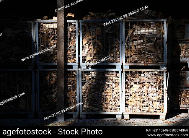 01 November 2022, Hamburg: Boxes filled with firewood stand in the sunshine under a shelter. Photo: Jonas Walzberg/dpa. - Hamburg/Hamburg/Germany