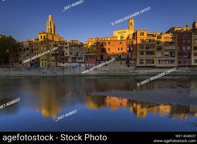 Girona Cathedral, Sant Feliu basilica and houses next to the Onyar river at sunset (Girona, Catalonia, Spain)