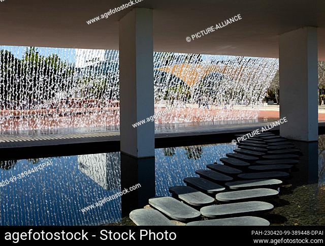 PRODUCTION - 06 April 2023, Portugal, Lissabon: The artificial waterfall in the garden ""Jardins da Agua"" in the Park of Nations