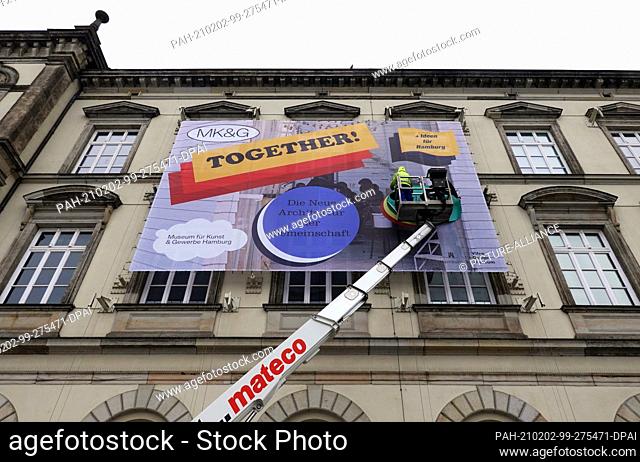 01 February 2021, Hamburg: A large poster with the inscription ""Together! The new architecture of community"" will be attached to the façade of the Museum für...