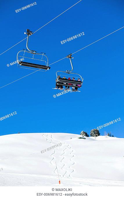 Skiers on a ski-lift of Zell am Ziller, Tirol, Austria. Vertical view