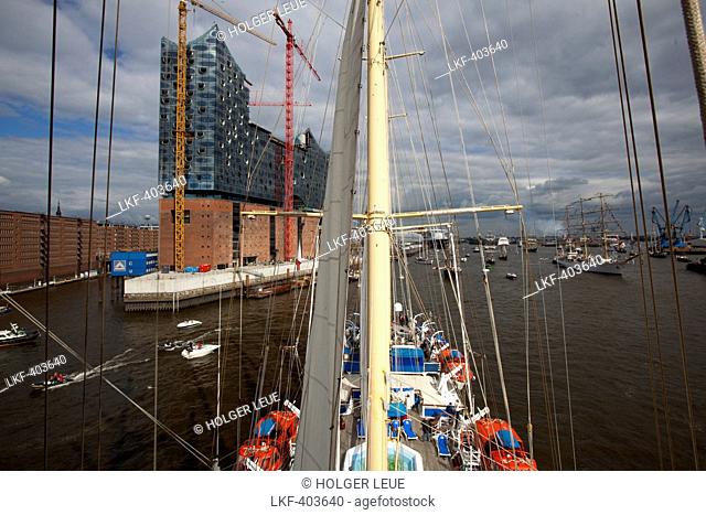 View from mast of sailing cruise ship Star Flyer on Elbe river as part of Hamburg harbour birthday celebrations with Elbe Philarmonic Hall under construction
