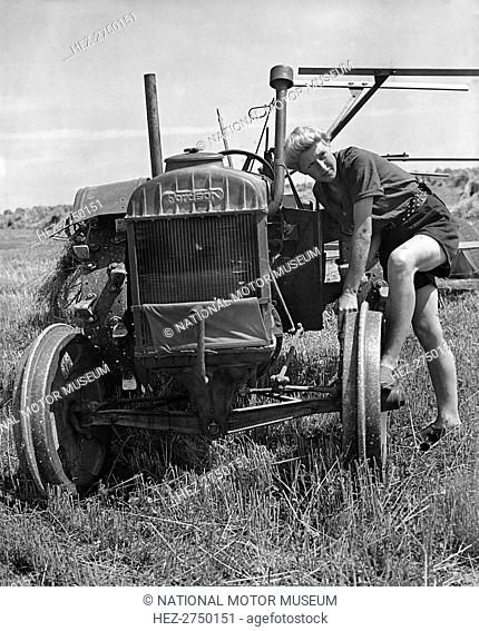 Fordson tractor, with Land girl 1940's. Creator: Unknown