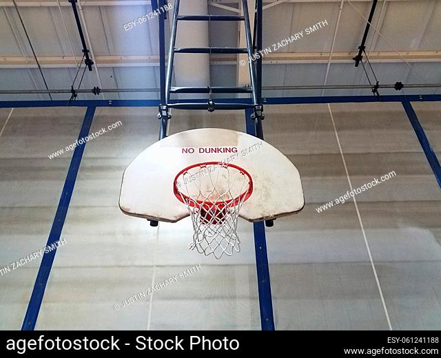basketball hoop with backboard saying no dunking in gym