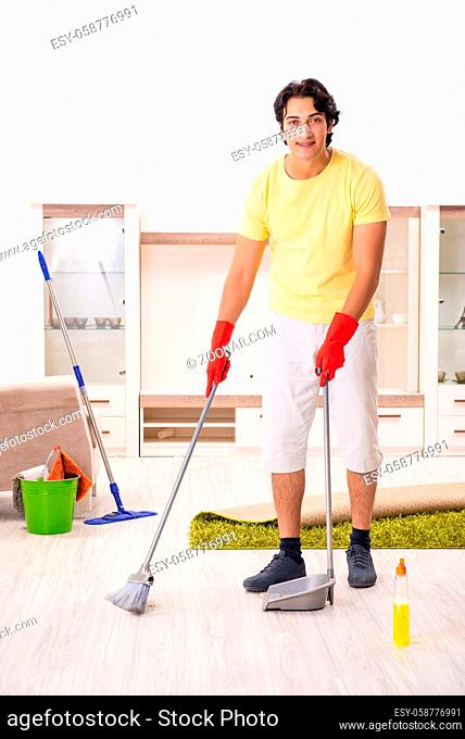 Young handsome man doing housework