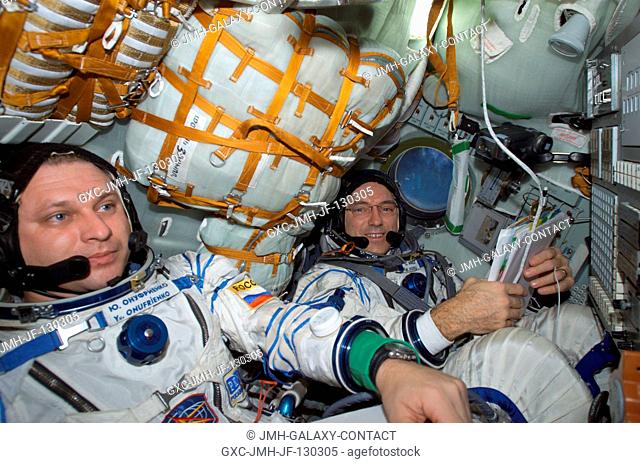 Cosmonaut Yury I. Onufrienko (left) and astronaut Carl E. Walz, Expedition Four mission commander and flight engineer, respectively, wearing Russian Sokol suits
