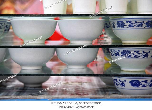 fresh home made yogurt is kept hygienic in small bowls in a market in Xining , Quinhai province , China