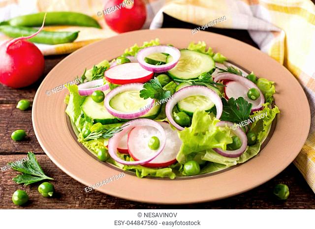 Fresh vegetable salad on wooden table. Healthy vegetarian food. Selective focus