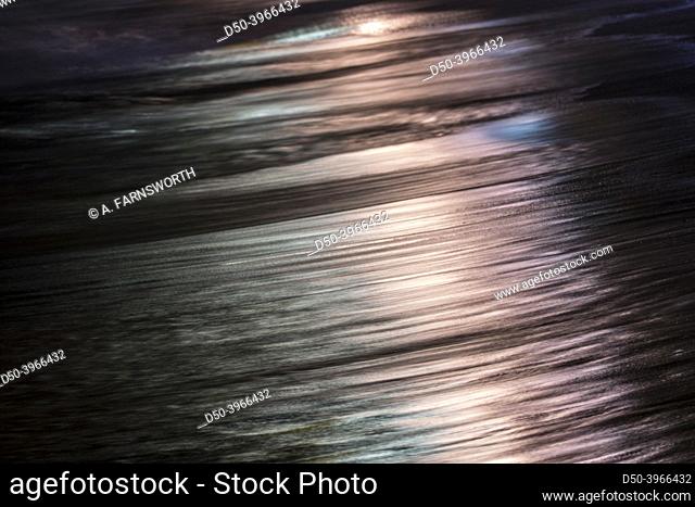 Unawatuna, Sri Lanka Abstract shot of a wave at night with city light reflections