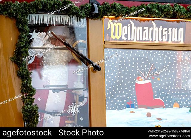 02 December 2023, Berlin: A man in a Santa Claus costume stands in the Christmas train of the Historische S-Bahn association