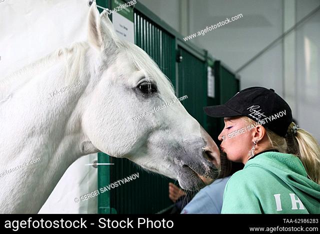 RUSSIA, MOSCOW - OCTOBER 4, 2023: A woman pets a horse at the 2023 Golden Autumn agricultural exhibition held at the Russian State Agrarian University – Moscow...