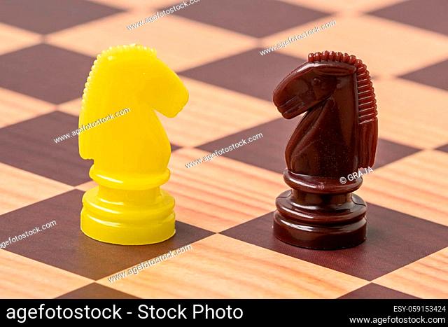 Shot of a chess board with brown and yellow horse
