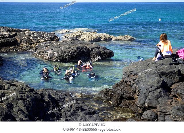 Scuba divers receiving training in rock pool, Burnett coast, Woongarra Marine Park, Queensland, Australia