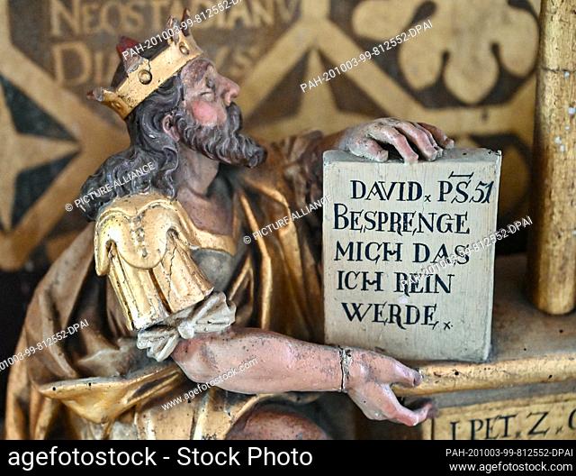 28 September 2020, Brandenburg, Eberswalde: The already cleaned altar with a figure in the medieval Church of Mary Magdalene