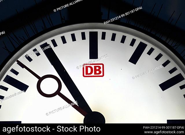 14 December 2023, Brandenburg, Potsdam: The word ""DB"" is written on the face of a large clock above a platform. Photo: Soeren Stache/dpa