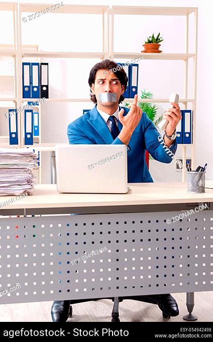 Young male employee with tape on the mouth