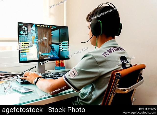 Madrid, Spain - August 23, 2019: Teenager is playing Counter Strike Global Offensive video game on PC. CSGO is an online multiplayer video game developed by...