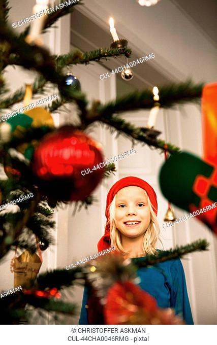 Smiling girl admiring Christmas tree