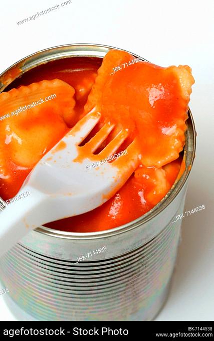 Ravioli in tin and plastic fork, ready meal with fork