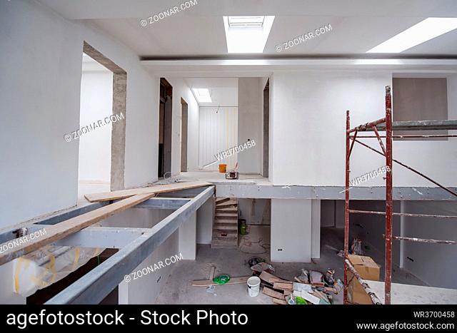 interior of construction site with scaffolding in a large modern unfinished duplex apartment