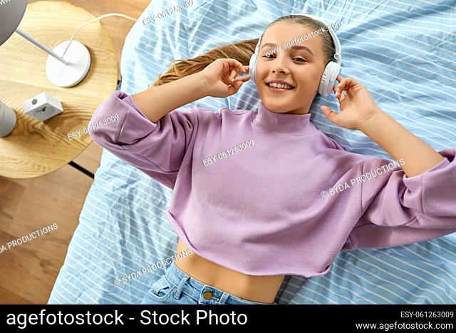 girl in headphones listening to music at home