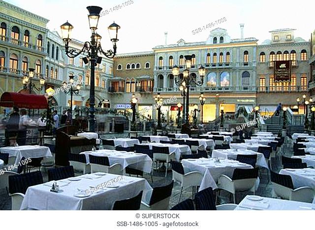 Dining tables with chairs in the courtyard of a hotel, Venetian Hotel, Las Vegas, Nevada, USA