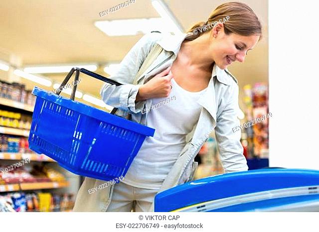 Beautiful young woman shopping in a grocery store/supermarket