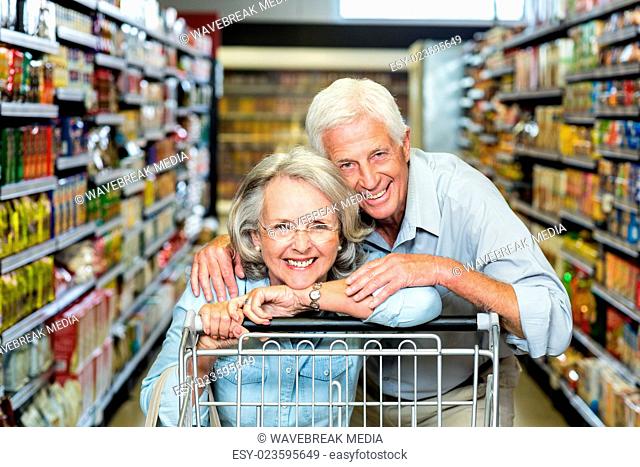 Happy senior couple with cart