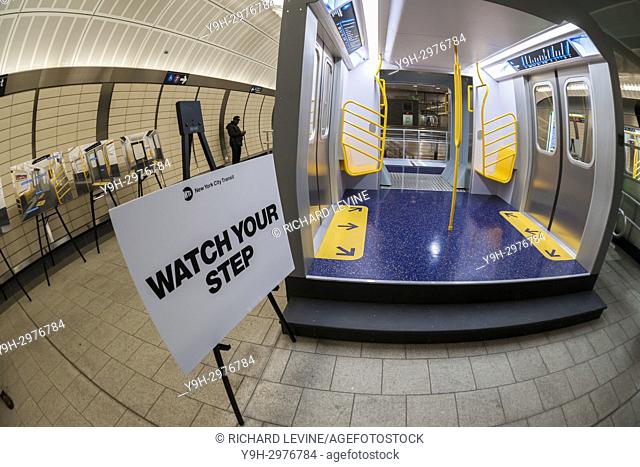 Commuters, media and subway aficionados inspect the mock-ups of the R211 subway cars placed in the 34th Street-Hudson Yards station mezzanine in New York on...