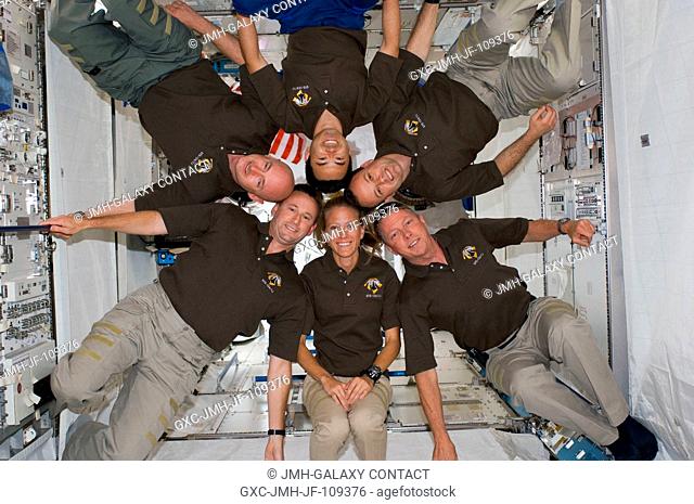 STS-124 crewmembers pose for a portrait following a joint news conference with the Expedition 17 crewmembers from the Kibo Japanese Pressurized Module of the...
