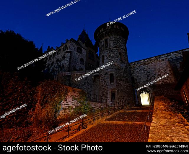 03 August 2022, Saxony-Anhalt, Wernigerode: Wernigerode Castle currently remains almost in the dark in the evening. The castle