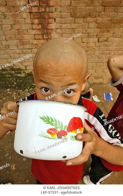 young boy at breakfast, one of many new Kung Fu schools in Dengfeng, near Shaolin, Song Shan, Henan province, China, Asia