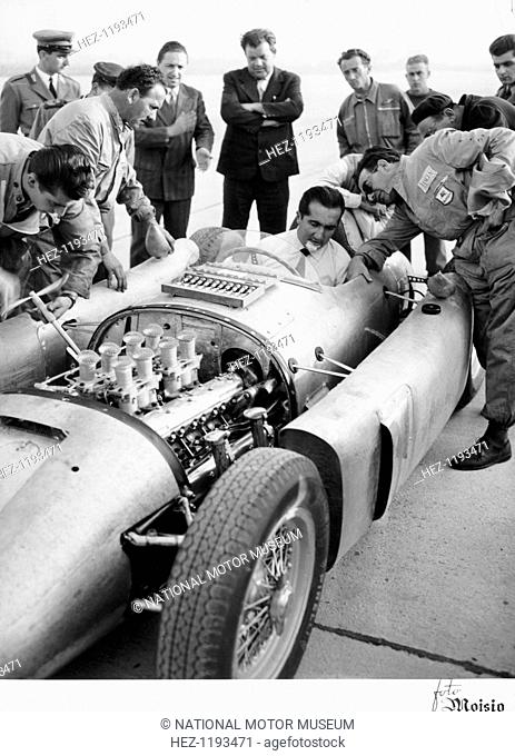 Alberto Ascari at the wheel of the new Lancia Grand Prix car, 1955. Enzo Ferrari signed Ascari up in 1949, and he won many races for Ferrari between 1950 and...