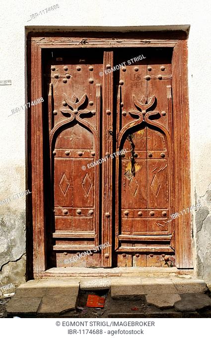 Carved wooden door in the old town of Sur, Sharqiya Region, Sultanate of Oman, Arabia, Middle East