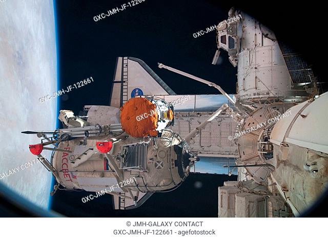 In the grasp of the station's robotic Canadarm2, the Russian-built Mini-Research Module 1 (MRM-1) is moved to be permanently attached to the Earth-facing port...