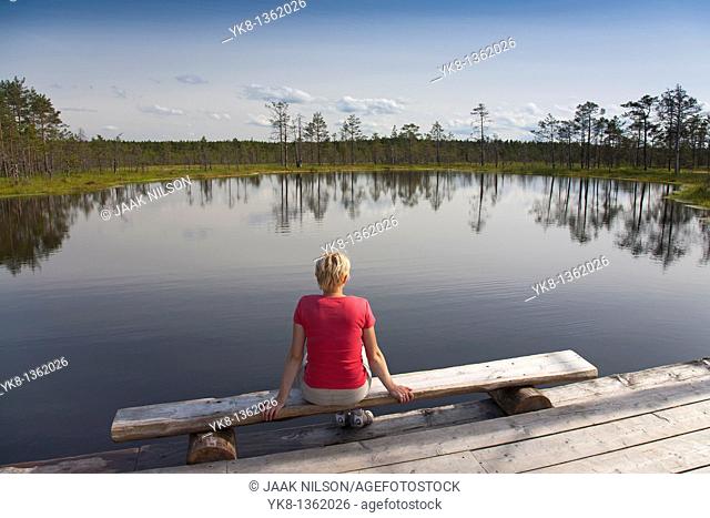 Young Woman Sitting by Bog Lake in Viru Bog, Lääne-Viru County, Estonia, Europe