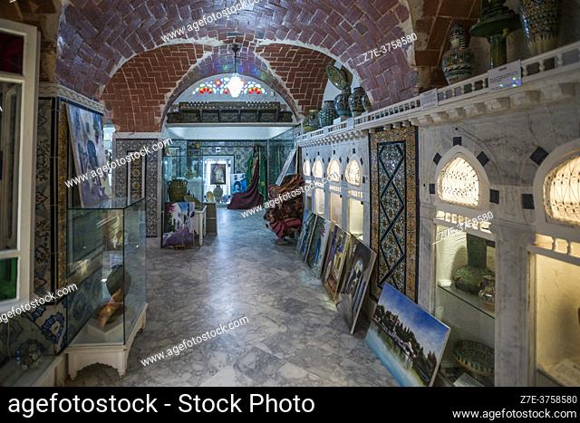 The stunning interior of a retail shop selling traditional arts and crafts. Walls are decorated with gorgeous tiles. Sidi Bou Said, Tunisia, Africa