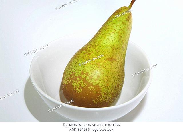 Conference pear in white bowl