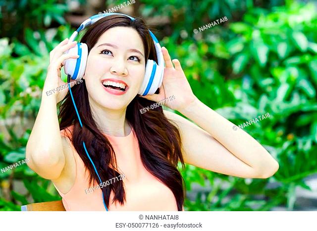closeup portrait of Asian woman relax style with song and headphone