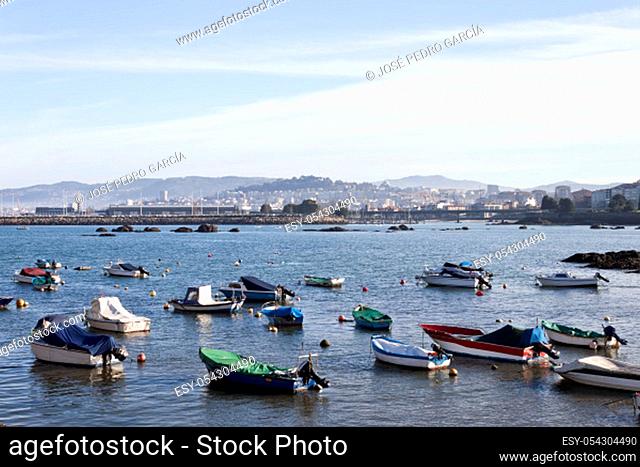 Boats in O Cocho beach in Alcabre neighborhood. Bouzas and Vigo city on background
