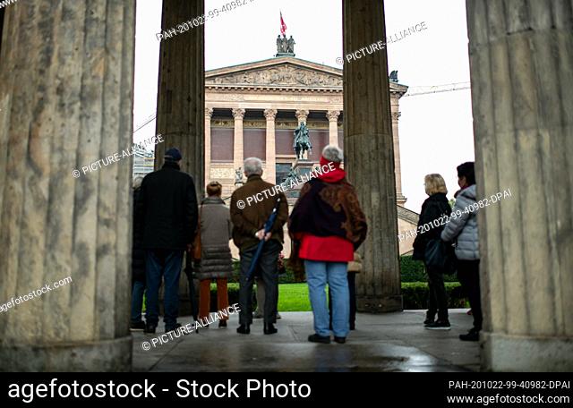 21 October 2020, Berlin: Tourists stand on the Museum Island between columns in front of the Alte Nationalgalerie. On Berlin's Museum Island dozens of works of...