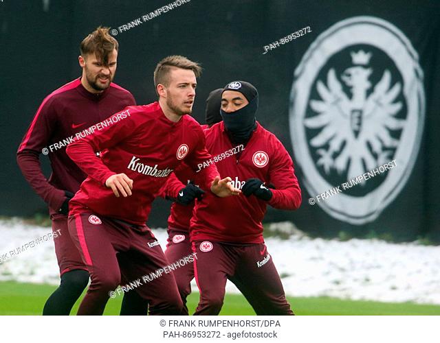 Newly signed German Bundesliga soccer club Eintracht Frankfurt player Max Besuschkow (C) with teammates Haris Seferovic (L) and Marco Fabian (R) during a...