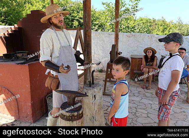 RUSSIA, SEVASTOPOL - AUGUST 27, 2023: A blacksmithing master class is given as part of the City of Craftsmen Medieval Crafts show at the Genoese manor of the...
