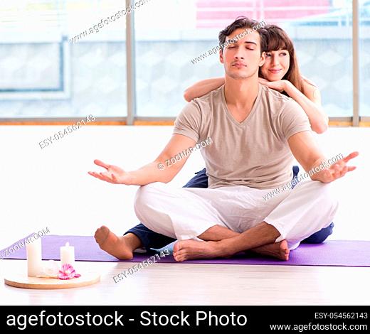 The personal coach helping during yoga session